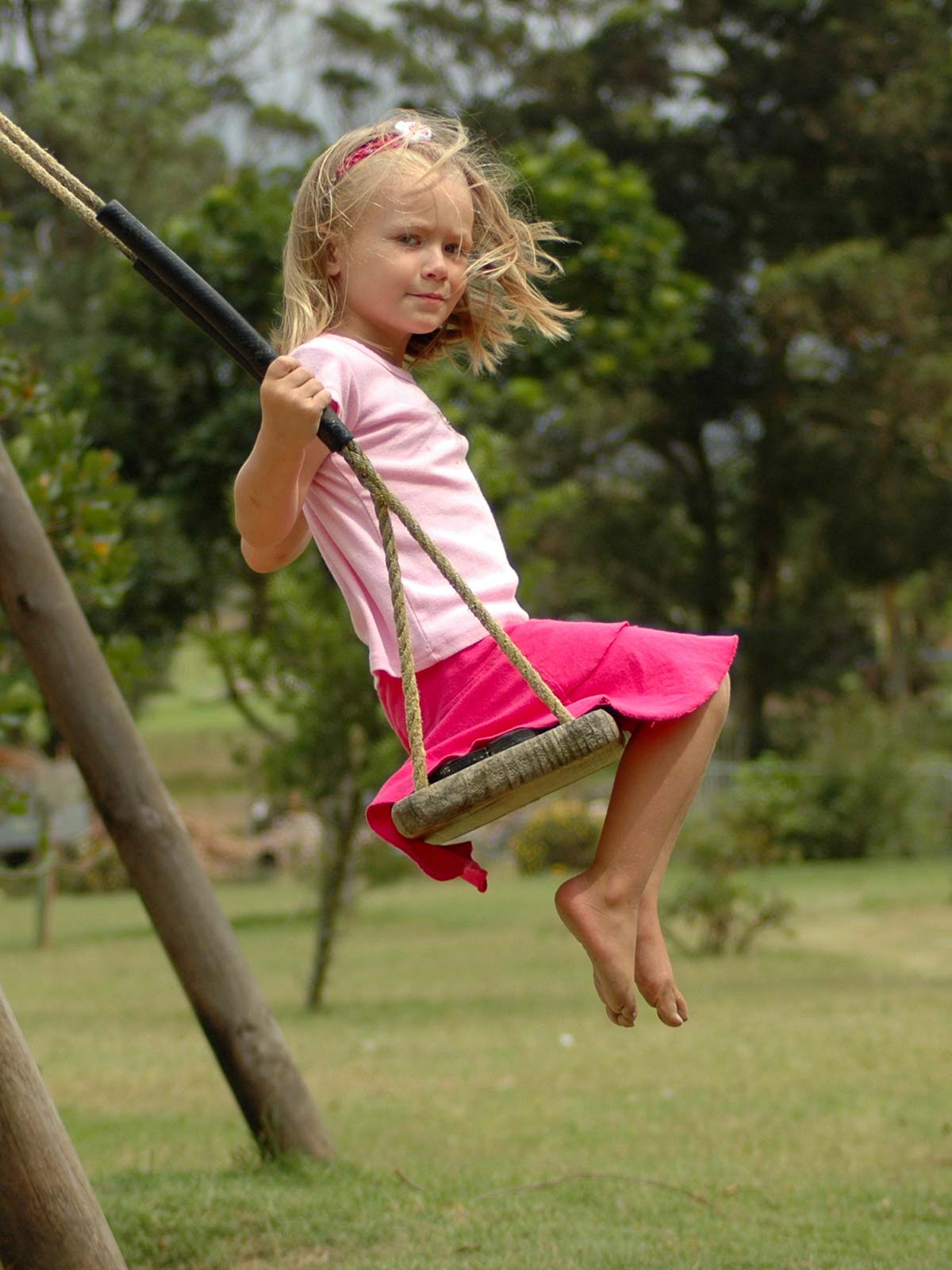 Girl on wooden swing