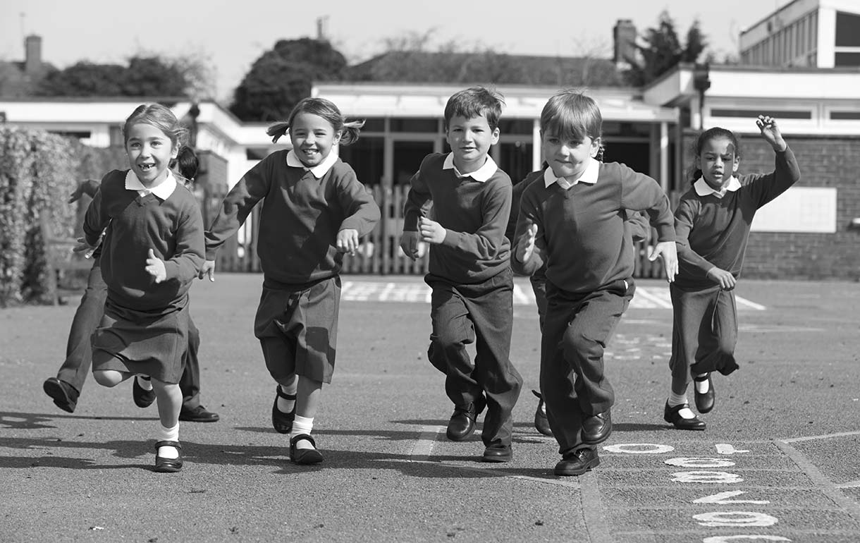 Children running across a playground