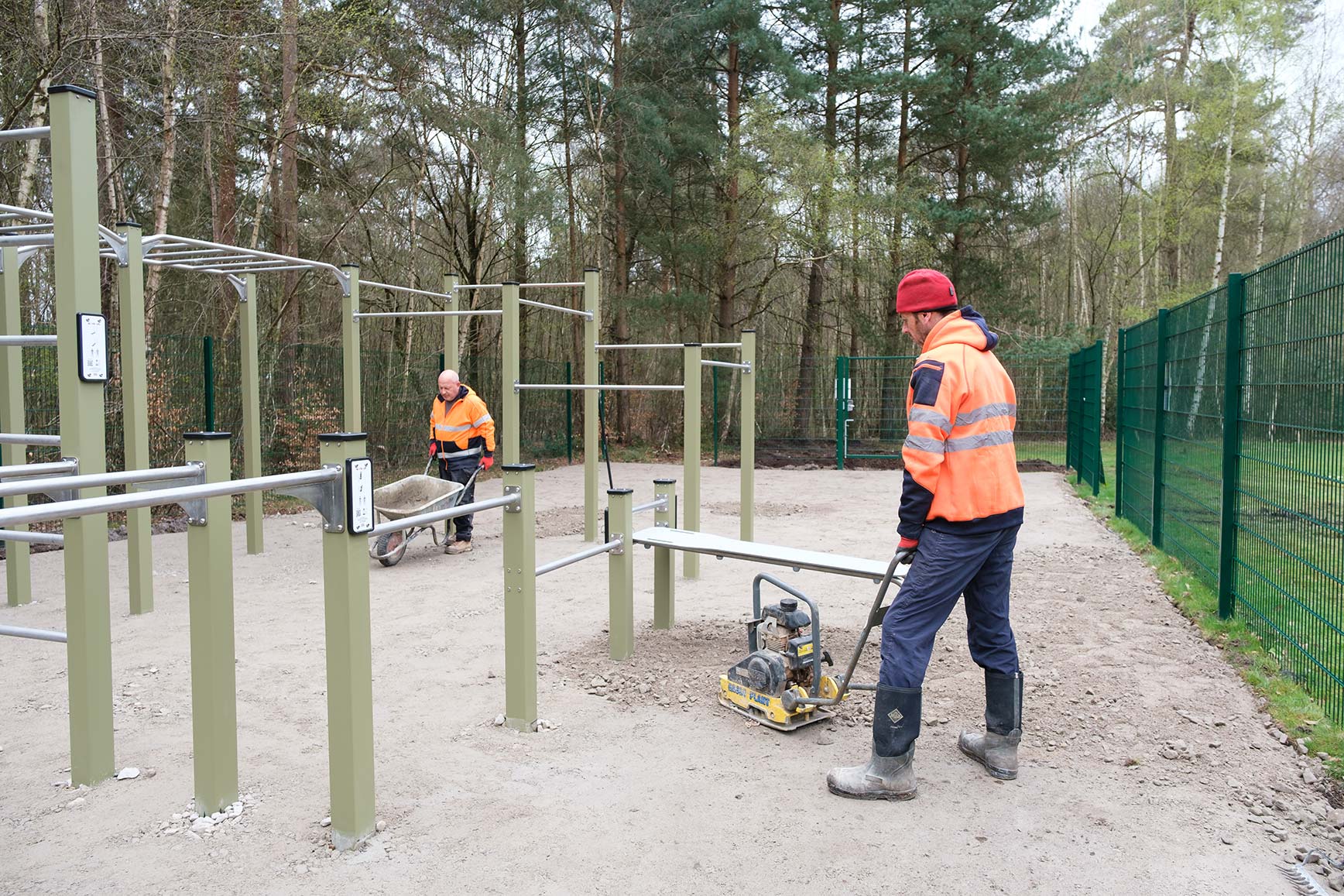 Lee and Mick leveling a play area foundation at Wellington College