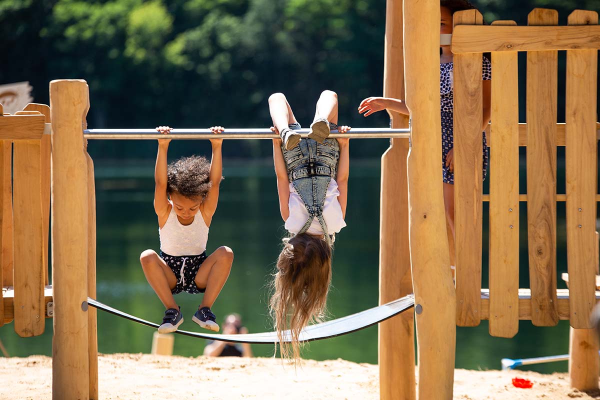 Girls hanging on cross bar