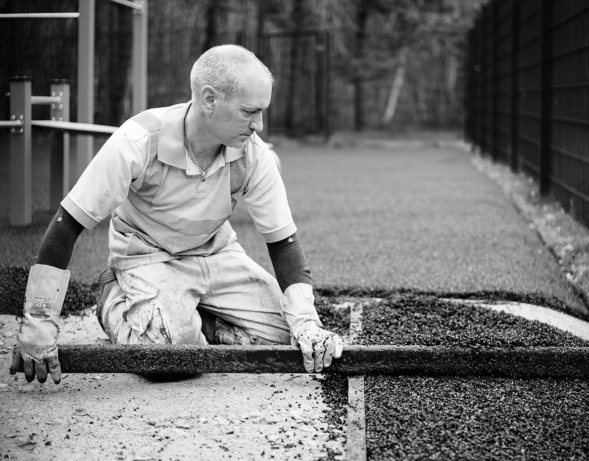 Man laying play area surface