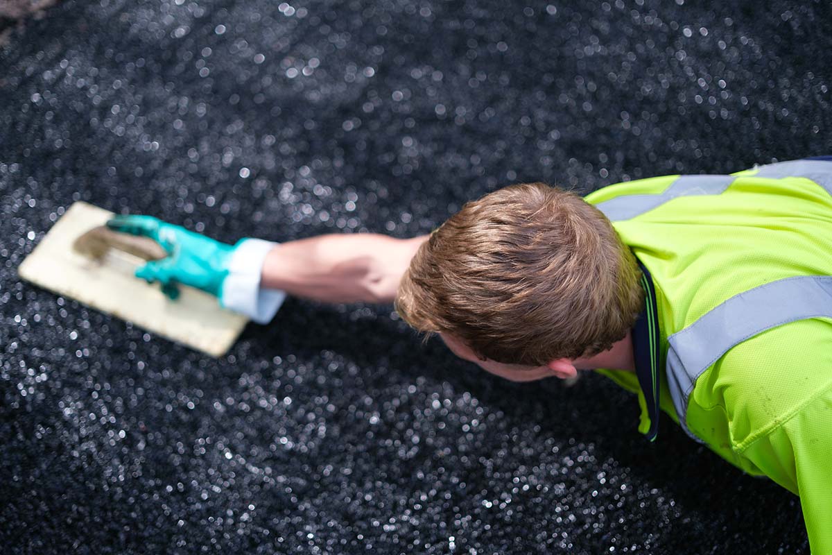 Man laying play area safety surface