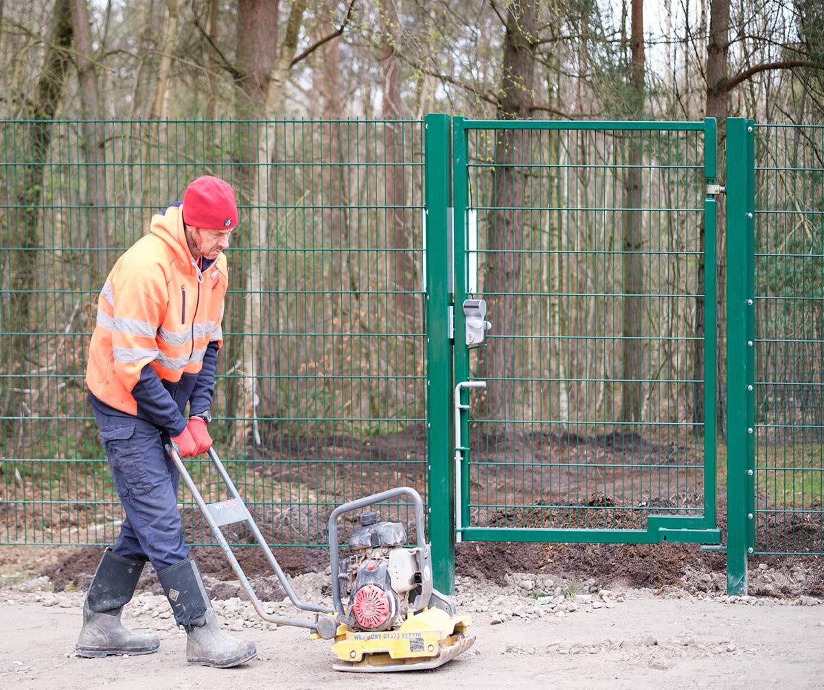 Mick working near steel gate installation