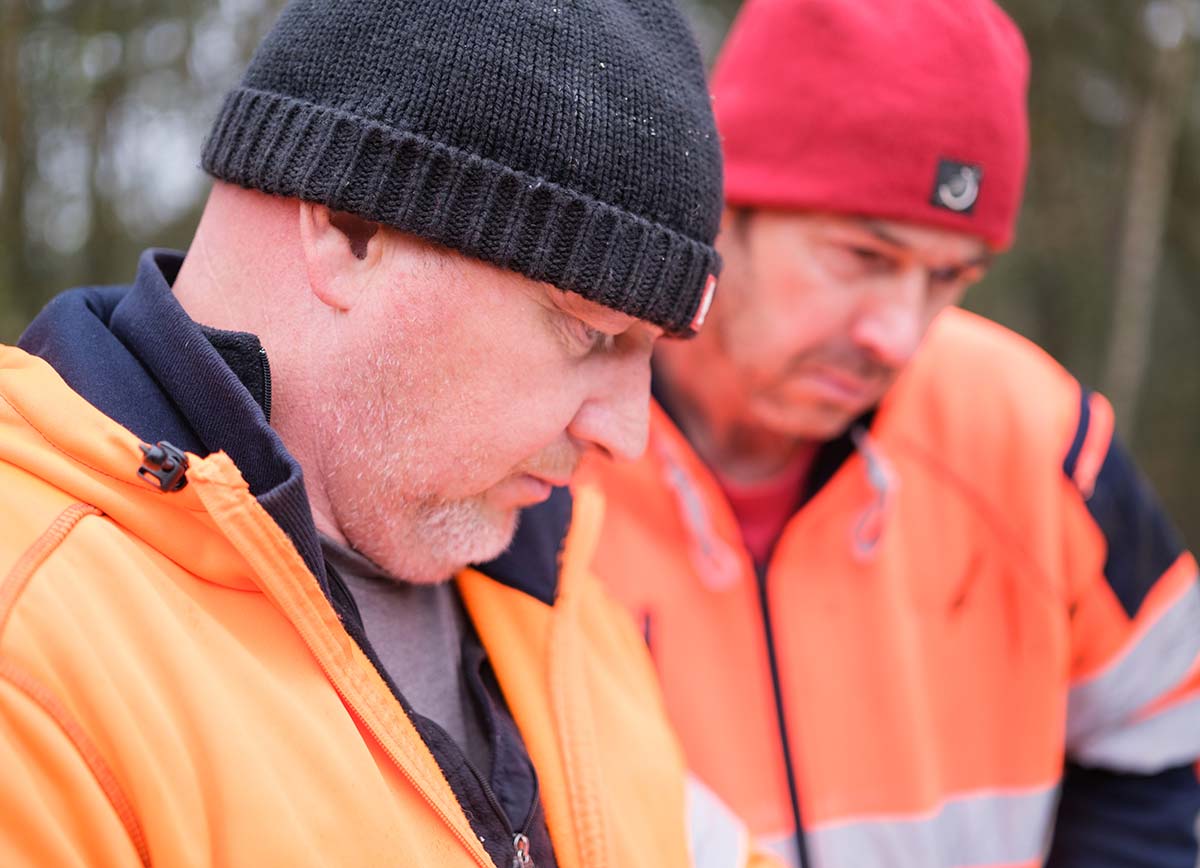 Lee and Mick going through papers on site