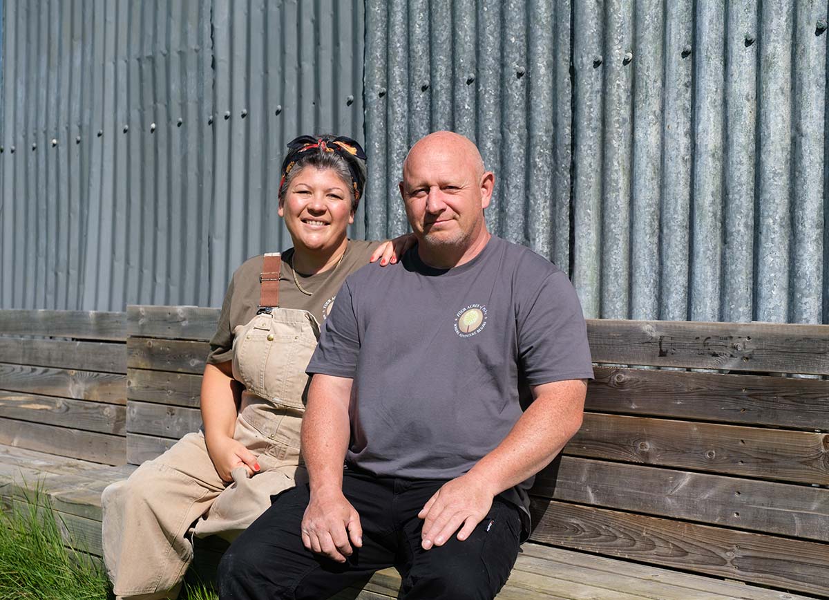 Lisa and Lee sitting outside infront of a cabin