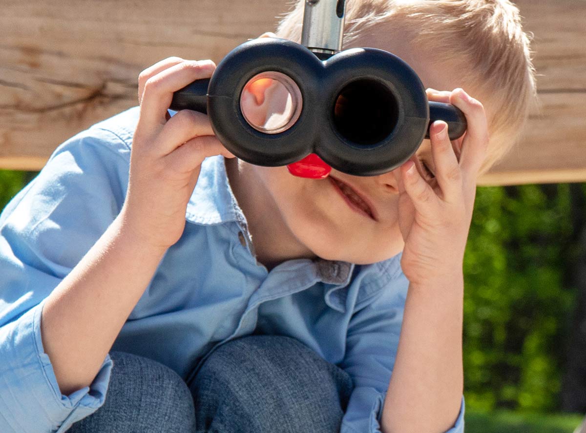 Young boy looking through telescope