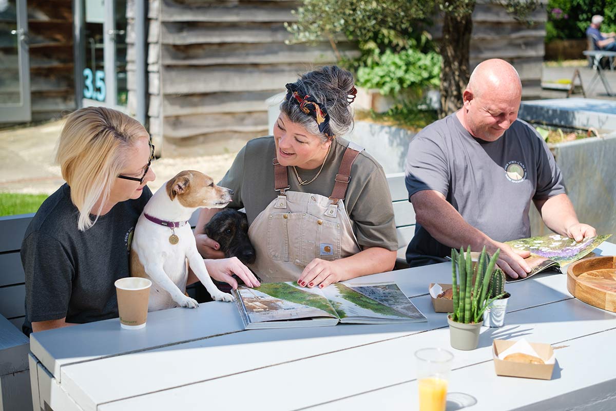 Natasha, Lisa and Lee sitting at a table discussing play area design